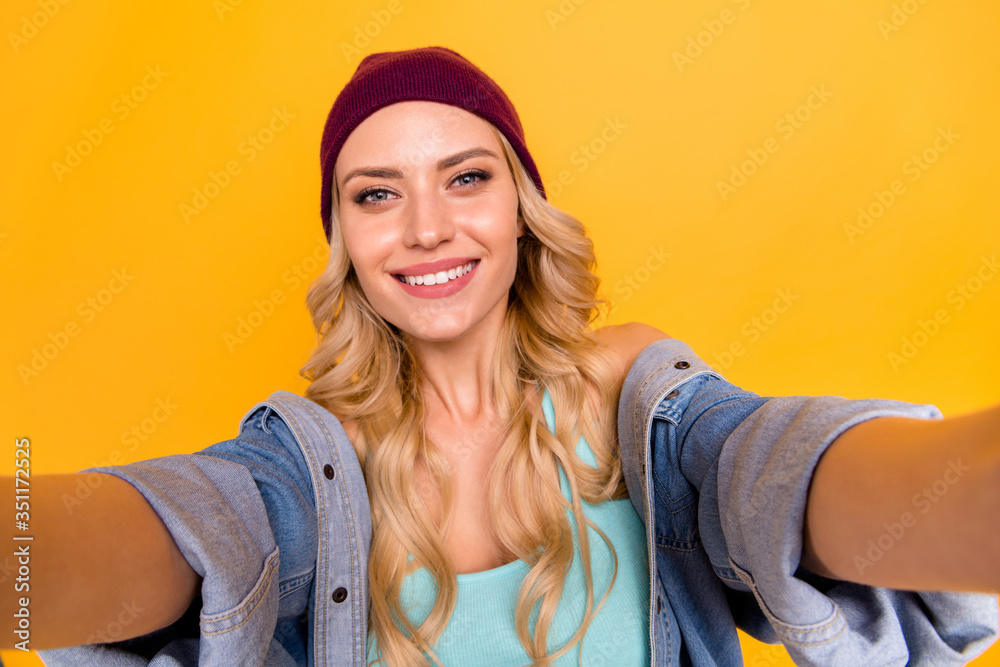 Closeup photo of pretty lady long curly hairdo good mood taking selfies blogger weekend free time wear casual turquoise singlet denim shirt isolated yellow color background Closeup photo of pretty lady long curly hairdo good mood taking selfies blogger weekend free time wear casual turquoise singlet denim shirt isolated yellow color background
