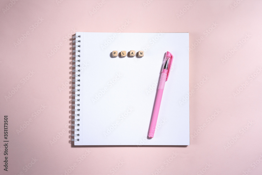 Opened book and pen on it on the pink background. Opened book and pen on it on the pink background.