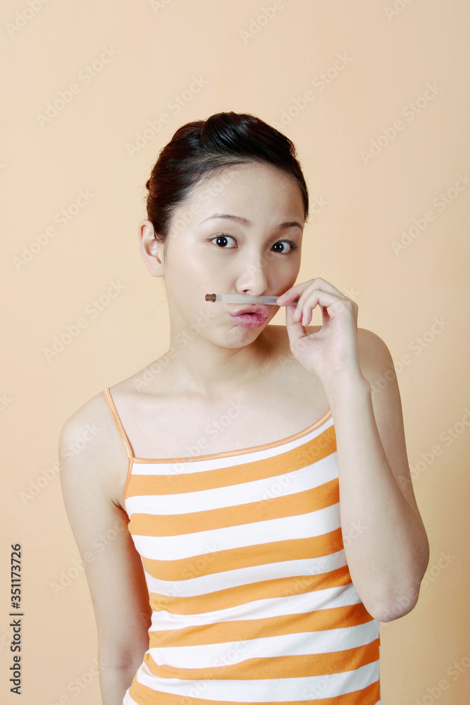 Woman holding a pen while puckering her lips. Woman holding a pen while puckering her lips.