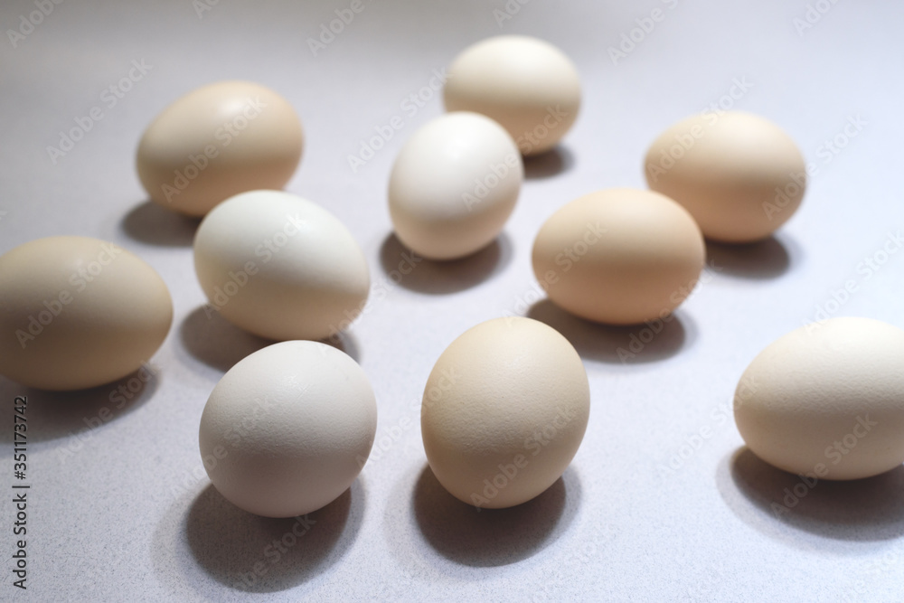 Many chicken eggs on the beige background. Many chicken eggs on the beige background.