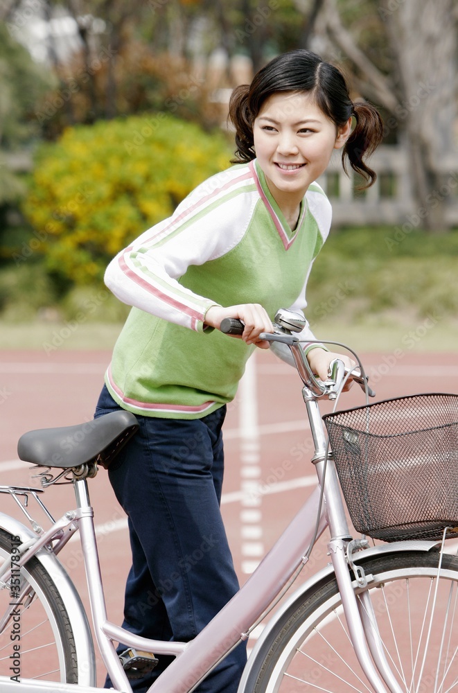 Obraz premium Girl with a bicycle.