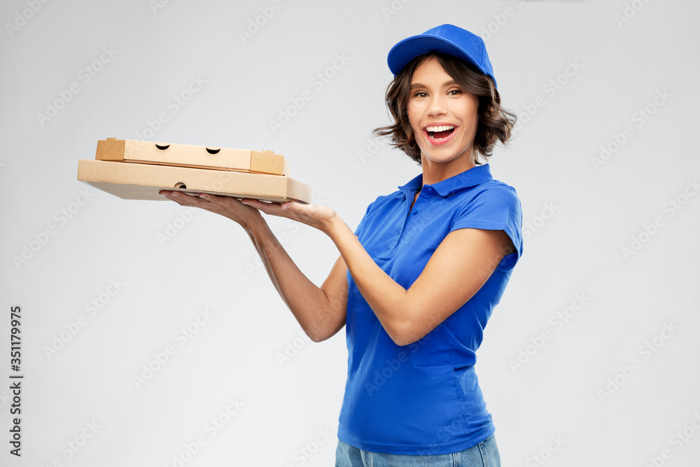 food, service and job concept - happy smiling delivery girl in blue uniform with takeaway pizza boxes over grey background food, service and job concept - happy smiling delivery girl in blue uniform with takeaway pizza boxes over grey background