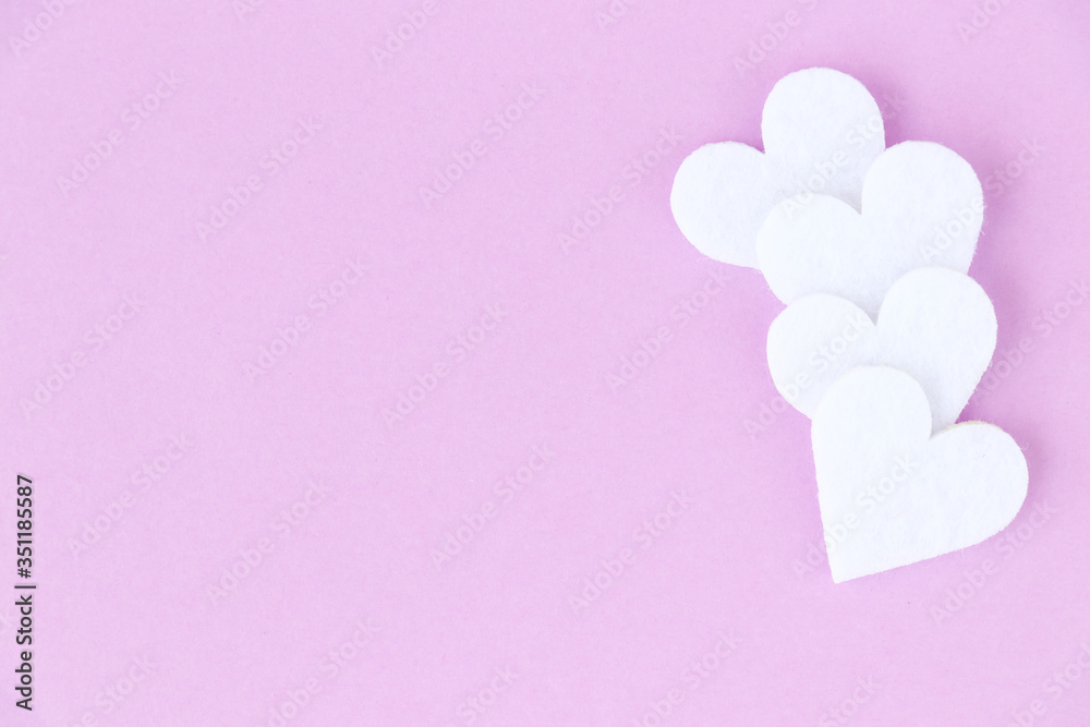 Love background. Decorative white fleece hearts on a light lilac background. Place for design.