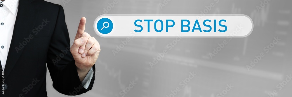 Fototapeta premium Stop Basis. Businessman (Man) in a suit pointing with his finger to a search box. The word is in focus. Blue Background. Business, Finance, Statistics, Analysis, Economy
