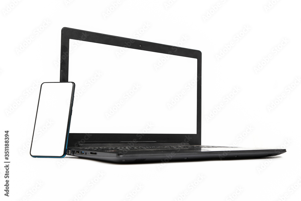 Laptop and smartphone with blank screen isolated on white background. Laptop and smartphone with blank screen isolated on white background.