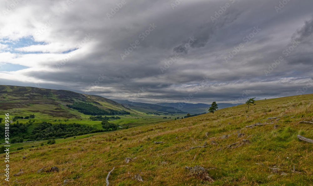 Looking down the Valley of Glen Clova from the hillside between Glen Moy at a site of Old Tree Felling operations, with threatening storm clouds above. Looking down the Valley of Glen Clova from the hillside between Glen Moy at a site of Old Tree Felling operations, with threatening storm clouds above.
