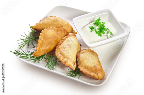 Chebureks on a white plate isolated on a white background