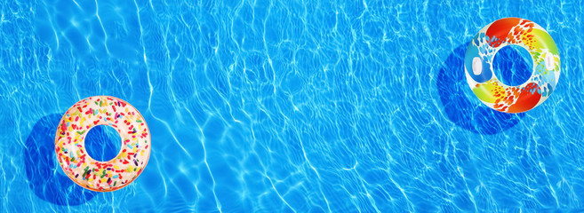 Different inflatable rings floating in swimming pool, top view. Banner design