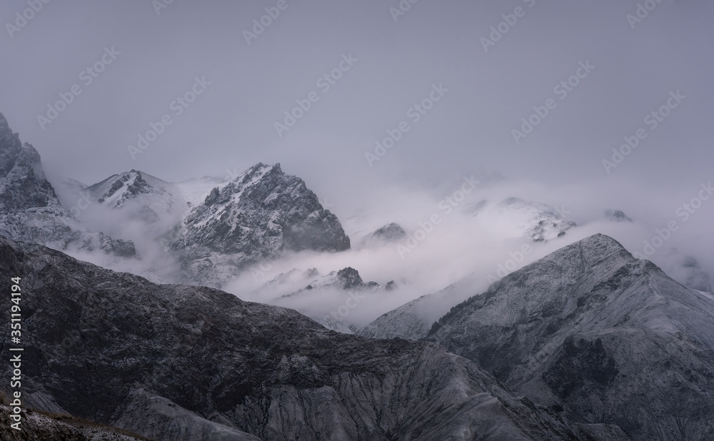 View of snow mountain surrounded by clouds with morning fog