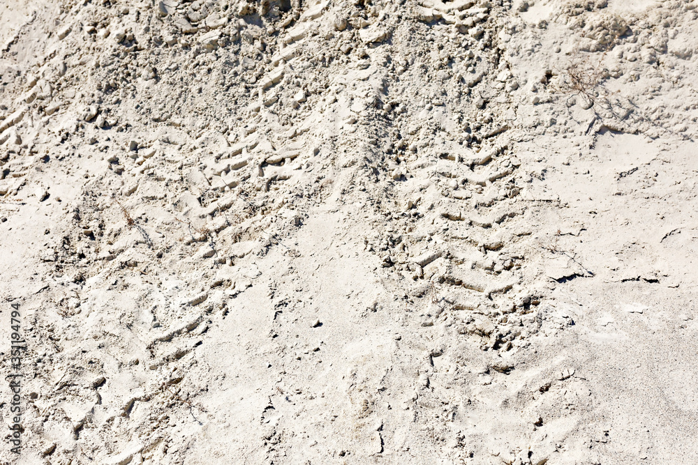 ATV tracks in the sand in harsh sunlight ATV tracks in the sand in harsh sunlight