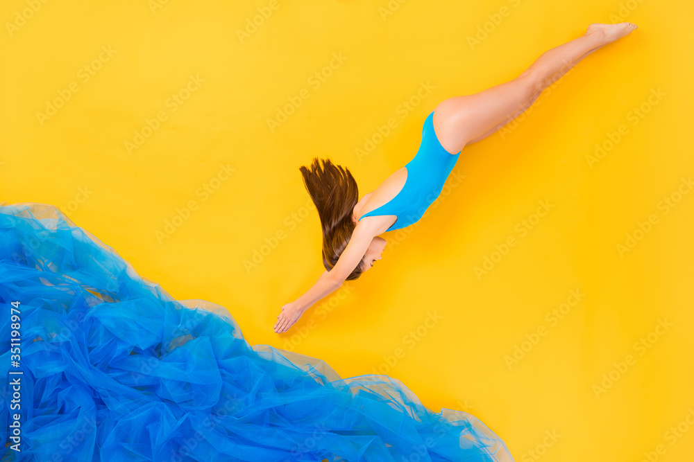 Top view above high angle flat lay flatlay lie concept full length body size view of attractive thin girl swimming diving deep water isolated on bright vivid shine vibrant yellow color background - obrazy, fototapety, plakaty 