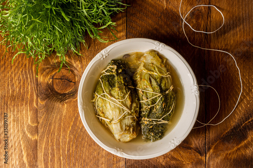 Padded escarole is a typical Neapolitan dish of peasant origin. Inside breadcrumbs, black olives, tomatoes, egg, oregano, garlic, parsley, salt. Vegetarian version.