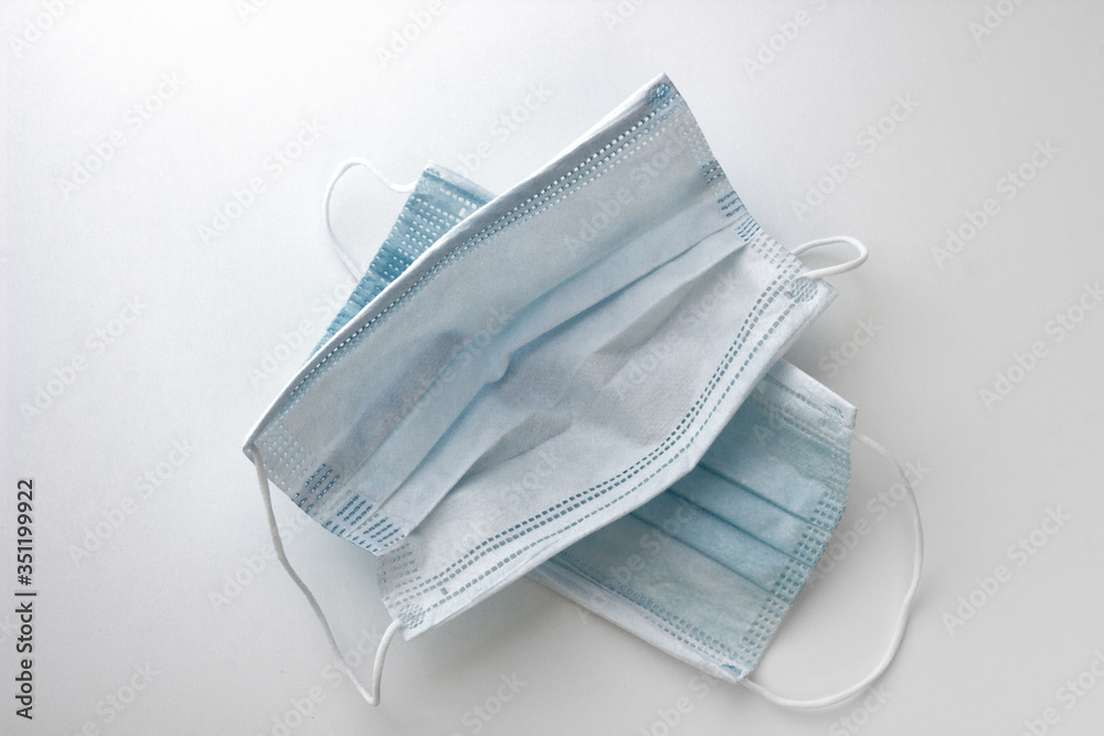 two used blue and torn masks on a white background two used blue and torn masks on a white background