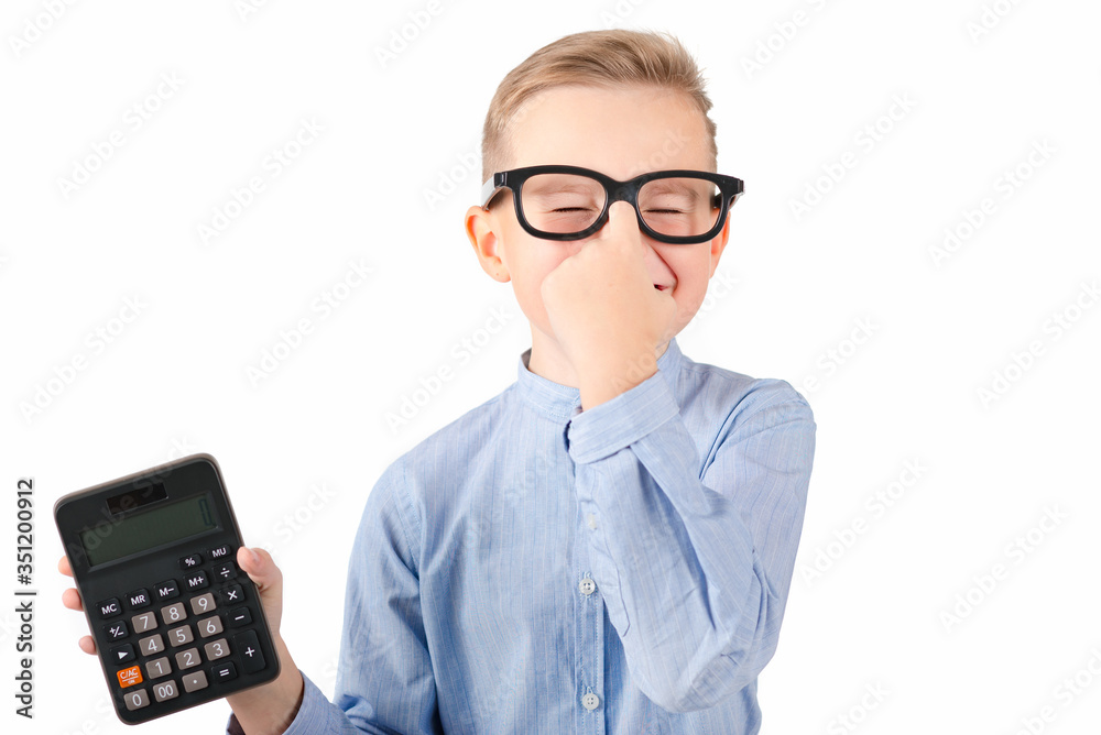 Surprised student holding calculator. Portrait of funny cute teen boy touching his head with hand. Shocked child with calculator looking at camera.White background. Surprised student holding calculator. Portrait of funny cute teen boy touching his head with hand. Shocked child with calculator looking at camera.White background.