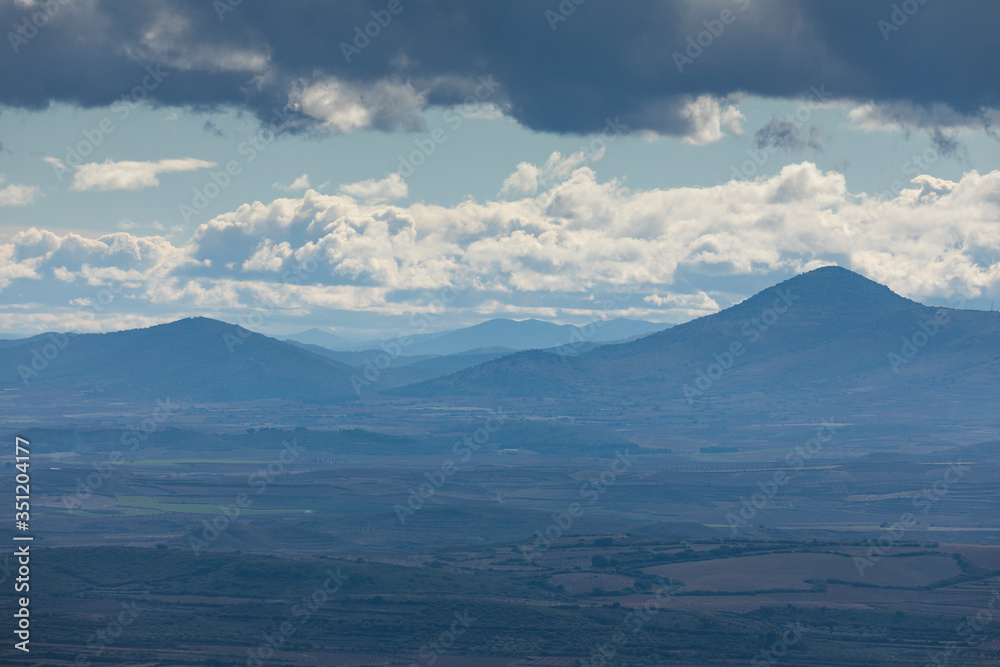 Landscape of mountains with clouds in the Moncayo area and the Iberian mountain system, looking towards Cabezo de Los Frailes in the Tabuenca area, Talamantes, near Borja, Zaragoza province.