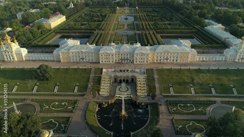 Aerial epic climb best of Russia famous imperial suburban palace St. Petersburg. Simmetrical cascade fountains. Unique park garden territory. Travel tourist best landmark peterhof. Sunset