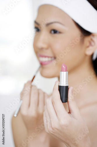 Woman using lip brush