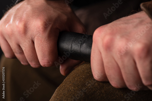 cropped view of medieval Scottish warrior with sword in hands © LIGHTFIELD STUDIOS