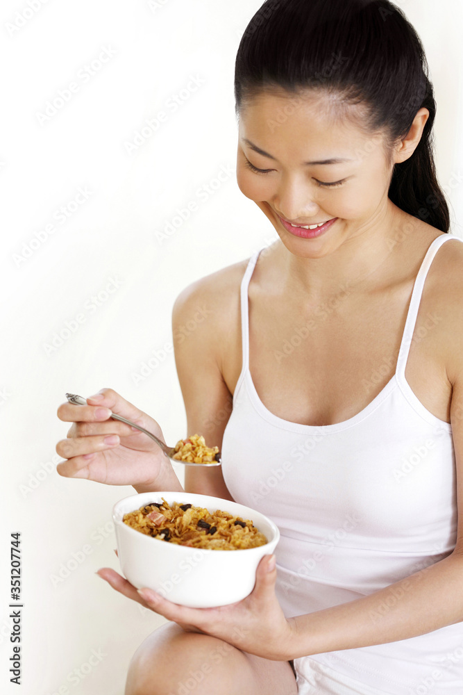 Woman enjoying her breakfast cereal Woman enjoying her breakfast cereal