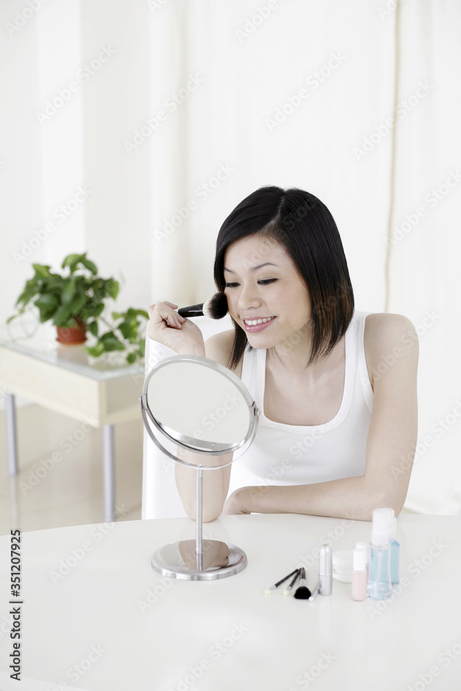 Woman applying make-up