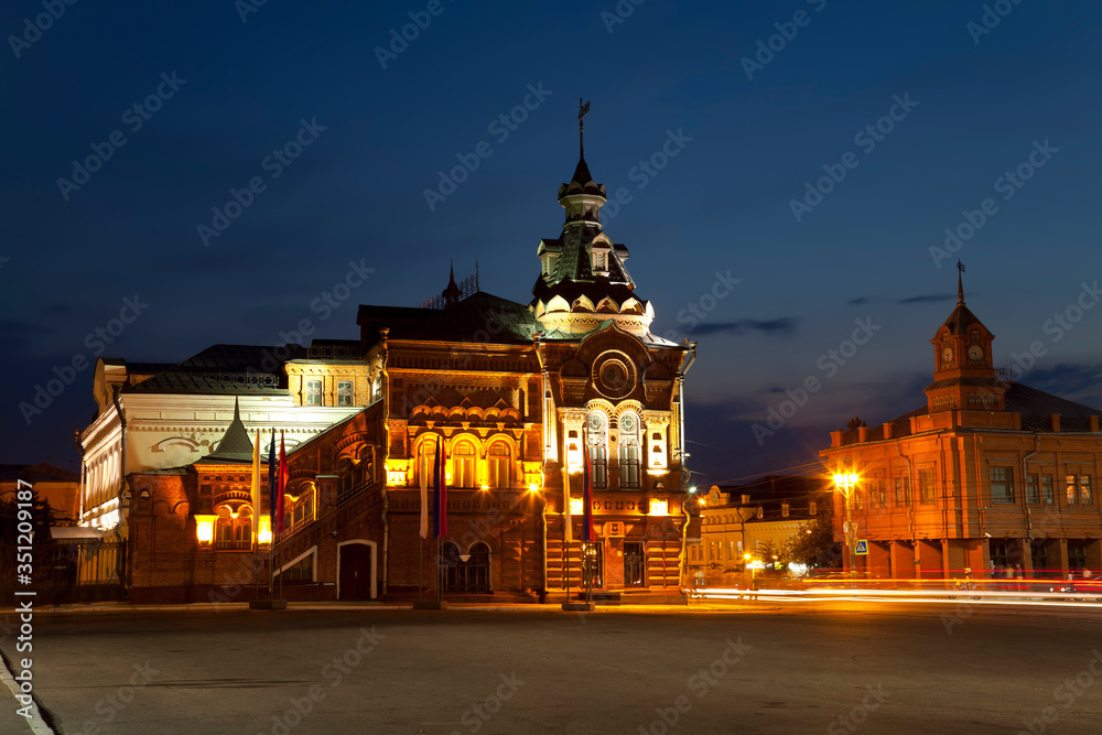 Sobornaya square with the building of the former city Duma, an architectural monument of the early 20th century and the new building of Sberbank at night. Vladimir, Russia