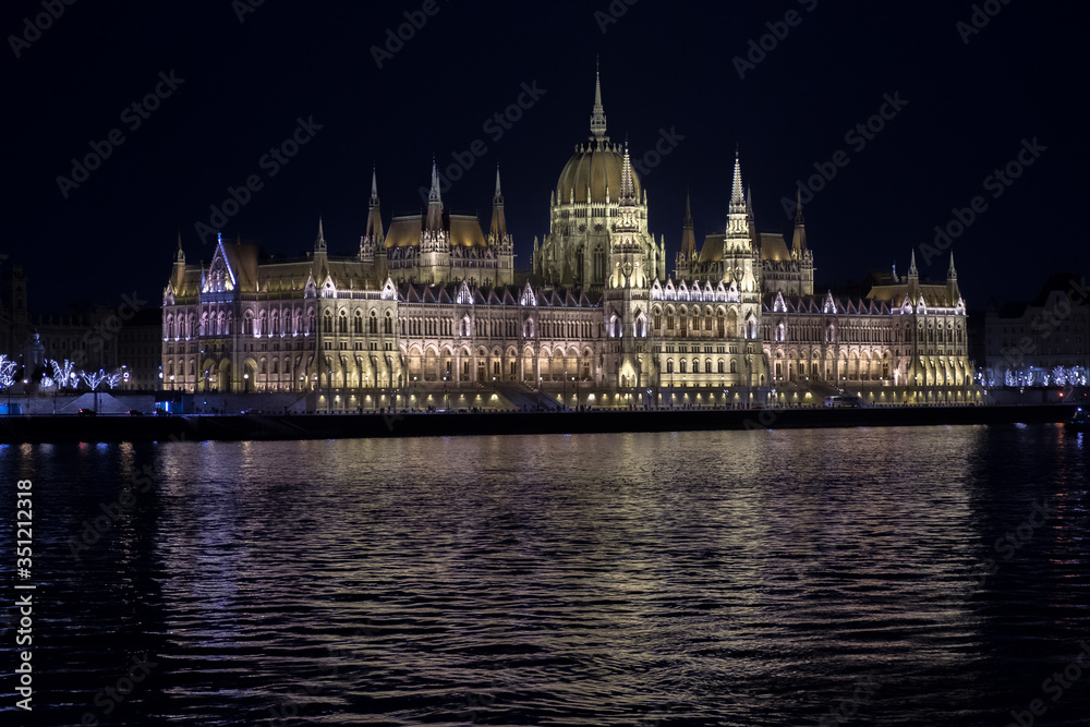 Beautiful illuminated famous Budapest parliament building along Danube River at night