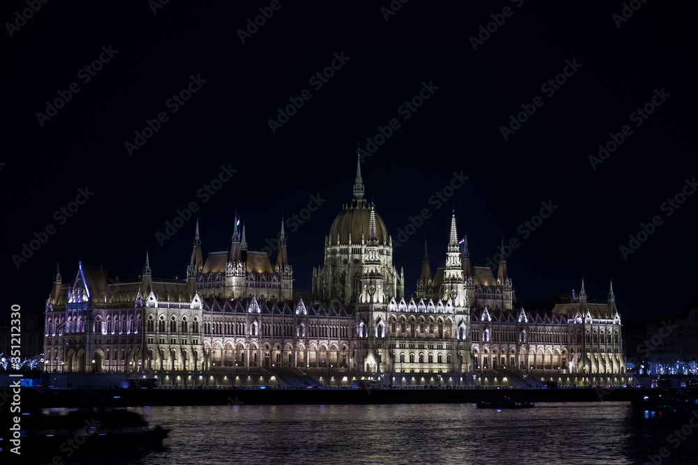 Beautiful illuminated famous Budapest parliament building along Danube River at night