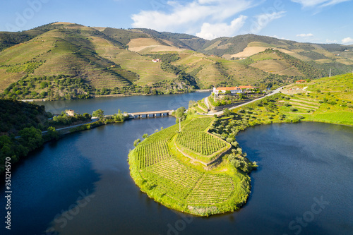 Douro wine valley region drone aerial view of s shape bend river in Quinta do Tedo at sunset, in Portugal