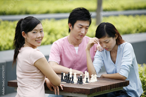 Man and women playing chess game