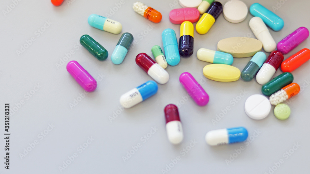 Top view multi-color tablets, pills, and capsules medicine use for treatment and cure the disease or sickness. Drug prescription use for medication in medical clinic, pharmacy Pharmaceutical service.