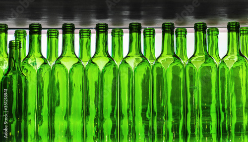 Many empty green glass wine bottles