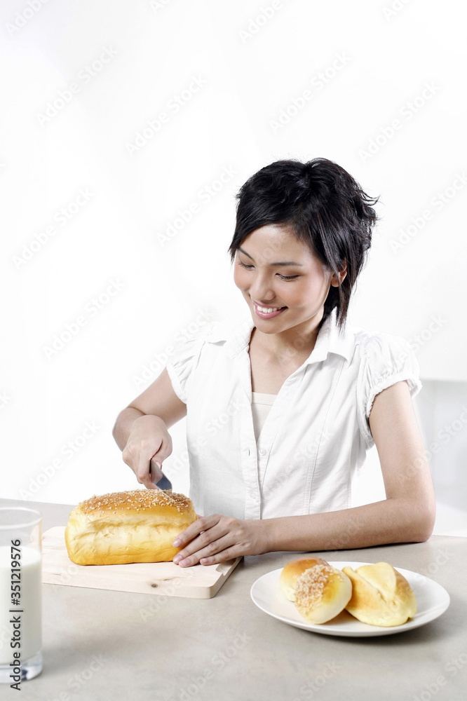 Woman cutting bread Woman cutting bread