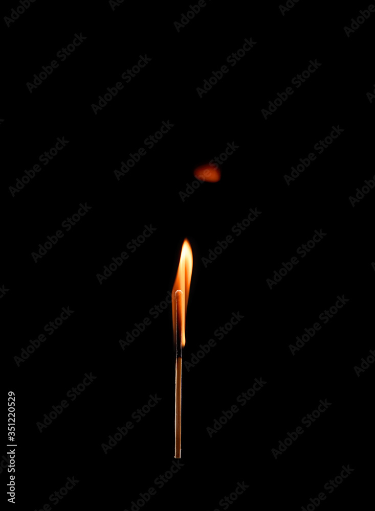 Burning match with a bright flame isolated on a black background Burning match with a bright flame isolated on a black background