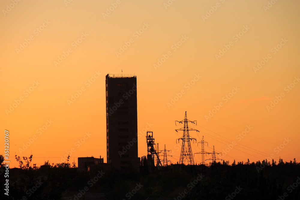 Mine tower silhouette at sunrise or sunset