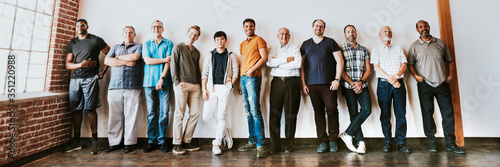 Cheerful diverse men standing in a row photo