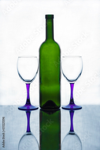 A bottle of wine and a glass glass