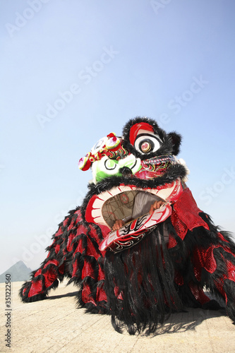 Performers in black and red lion costume