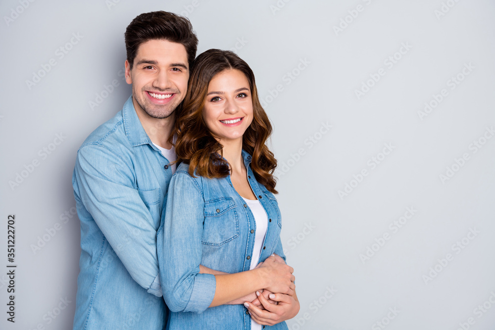 Portrait of positive cheerful charming married spouses hug embrace cuddle enjoy togetherness copyspace wear casual student denim style outfit isolated over gray color background Portrait of positive cheerful charming married spouses hug embrace cuddle enjoy togetherness copyspace wear casual student denim style outfit isolated over gray color background