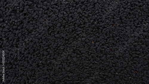 Fresh asphalt. Black structural background