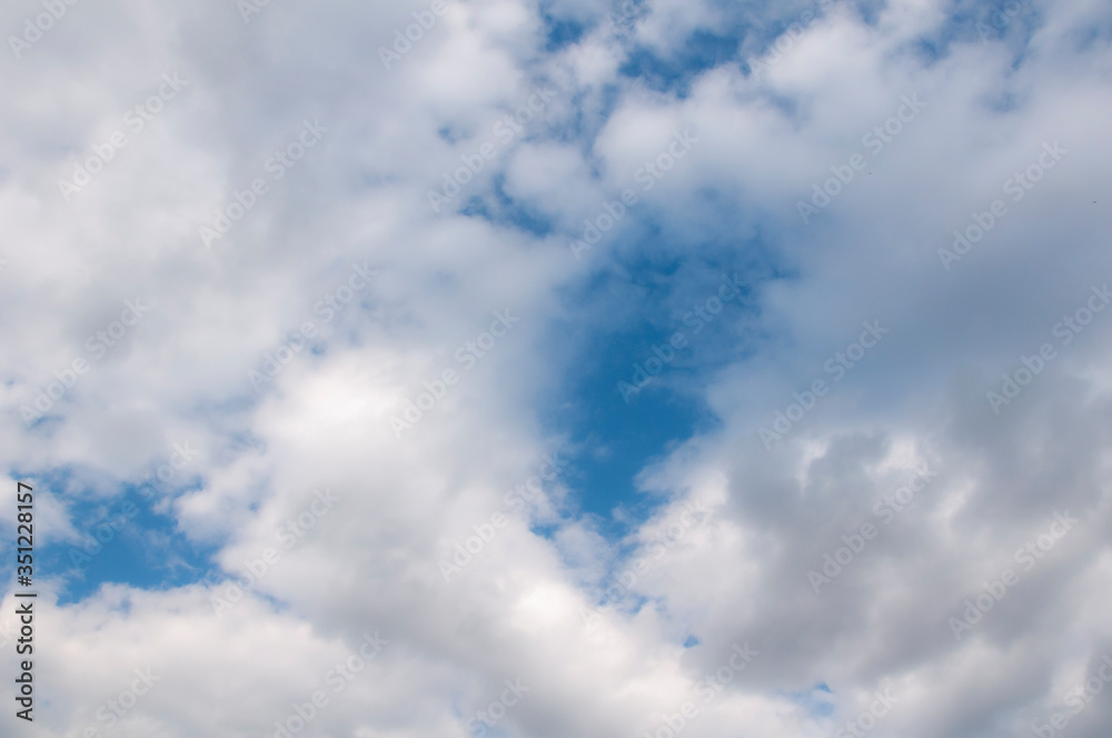 White clouds on a blue sky. Beautiful natural background. White clouds on a blue sky. Beautiful natural background.
