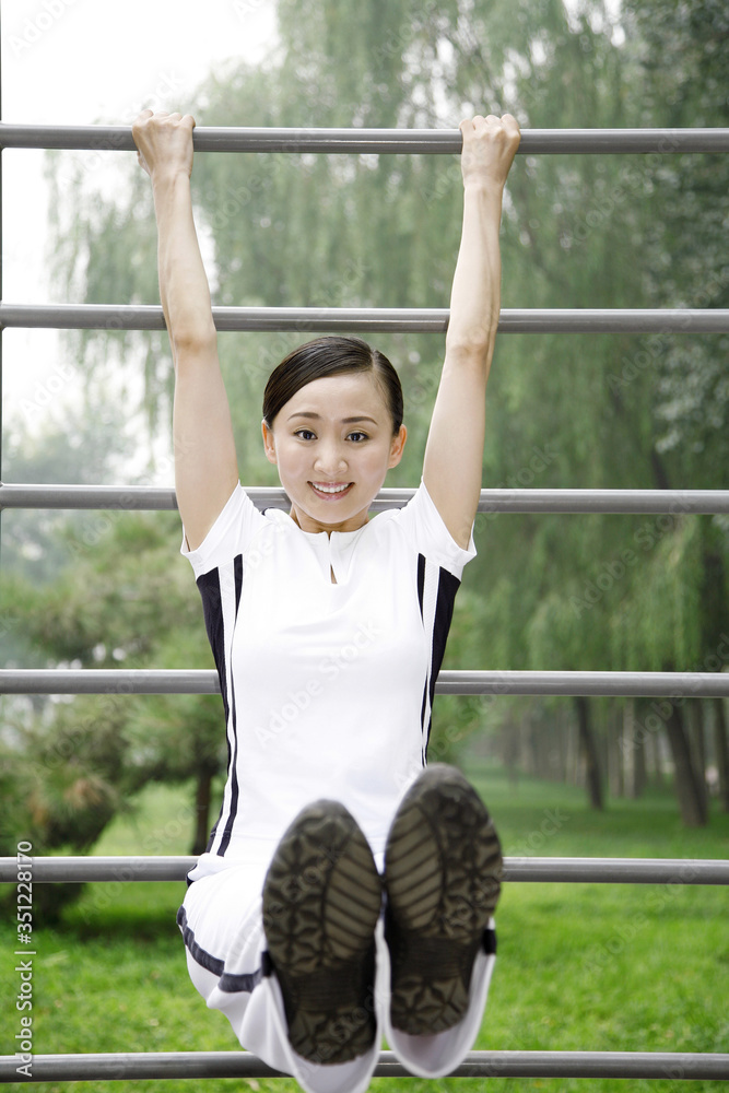 Fototapeta premium Woman lifting herself off the ground