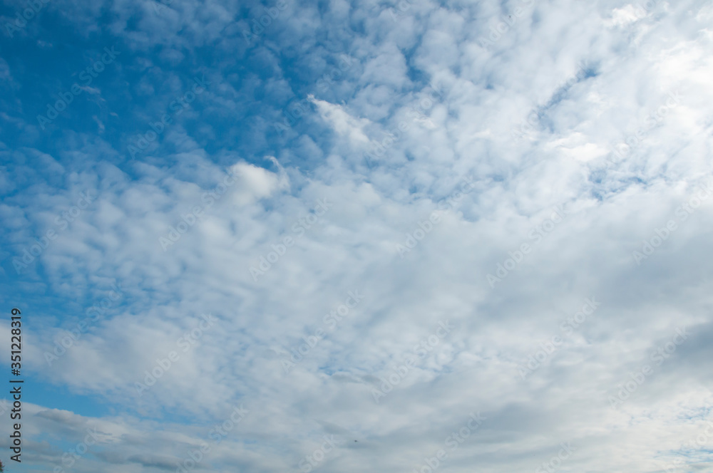 White clouds on a blue sky. Beautiful natural background White clouds on a blue sky. Beautiful natural background