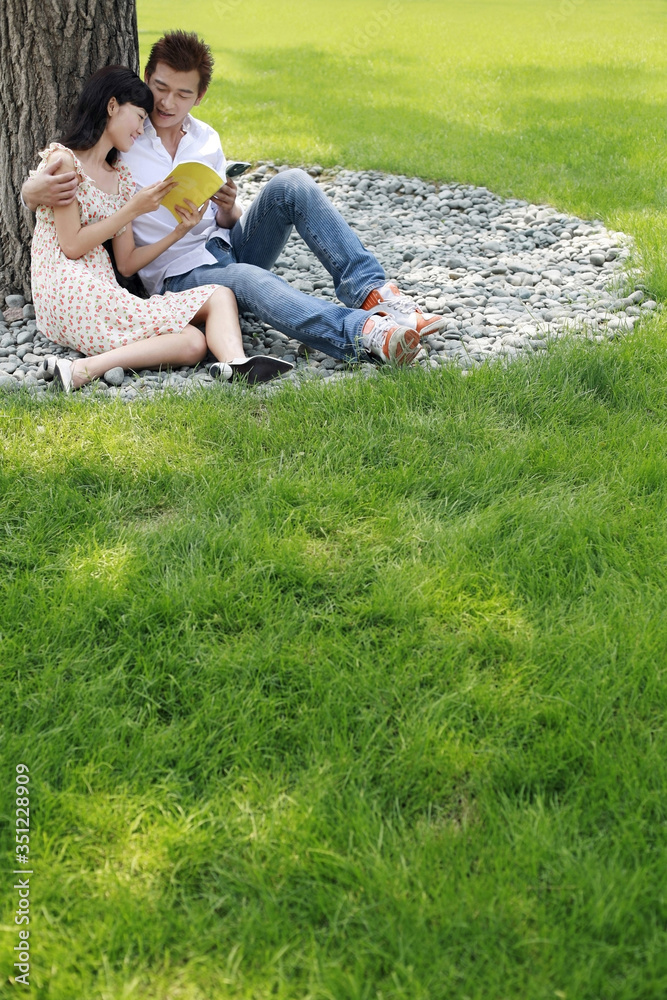 Man and woman reading in the park Man and woman reading in the park
