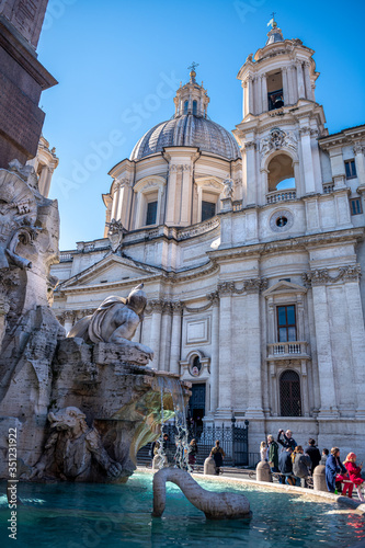 Przepięknie rzeźbione fontanny oraz katedra na Piazza Navonna w Rzymie. Słoneczny letni dzień. Włochy, Europa