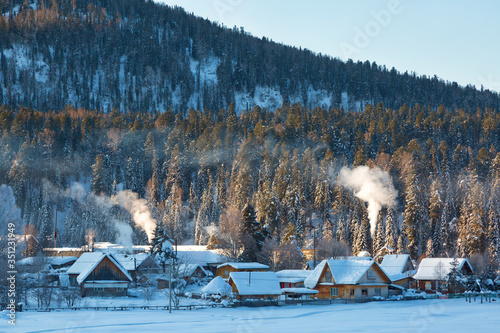 Winter landscape with a village on a background of a mountain on day, Altai, Russia © Shchipkova Elena