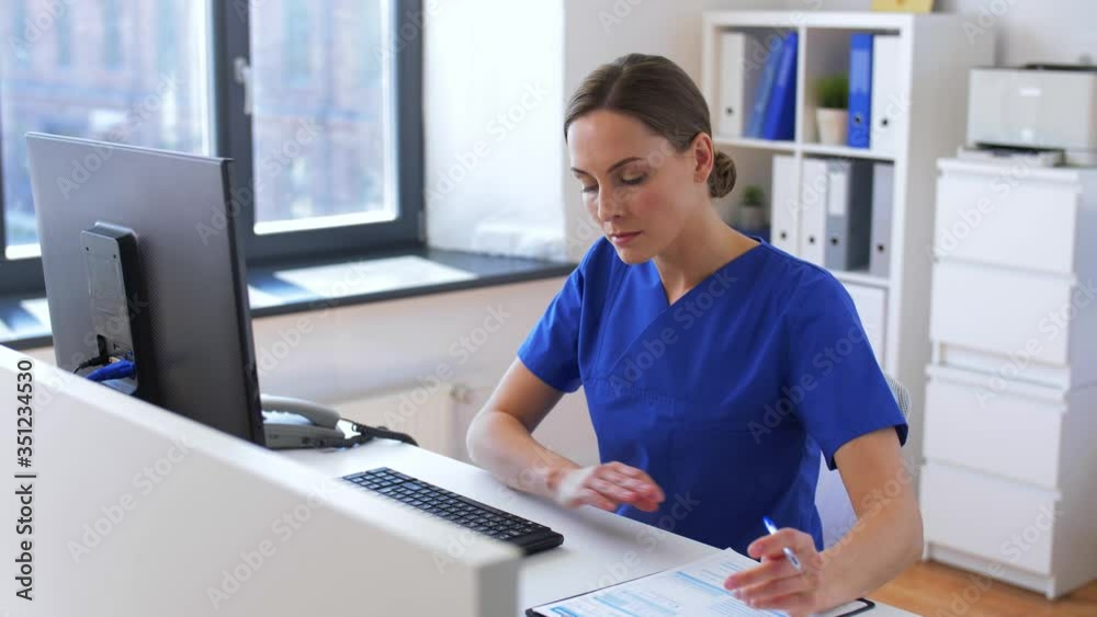 medicine, technology and healthcare concept - female doctor or nurse with computer and medical report working at hospital