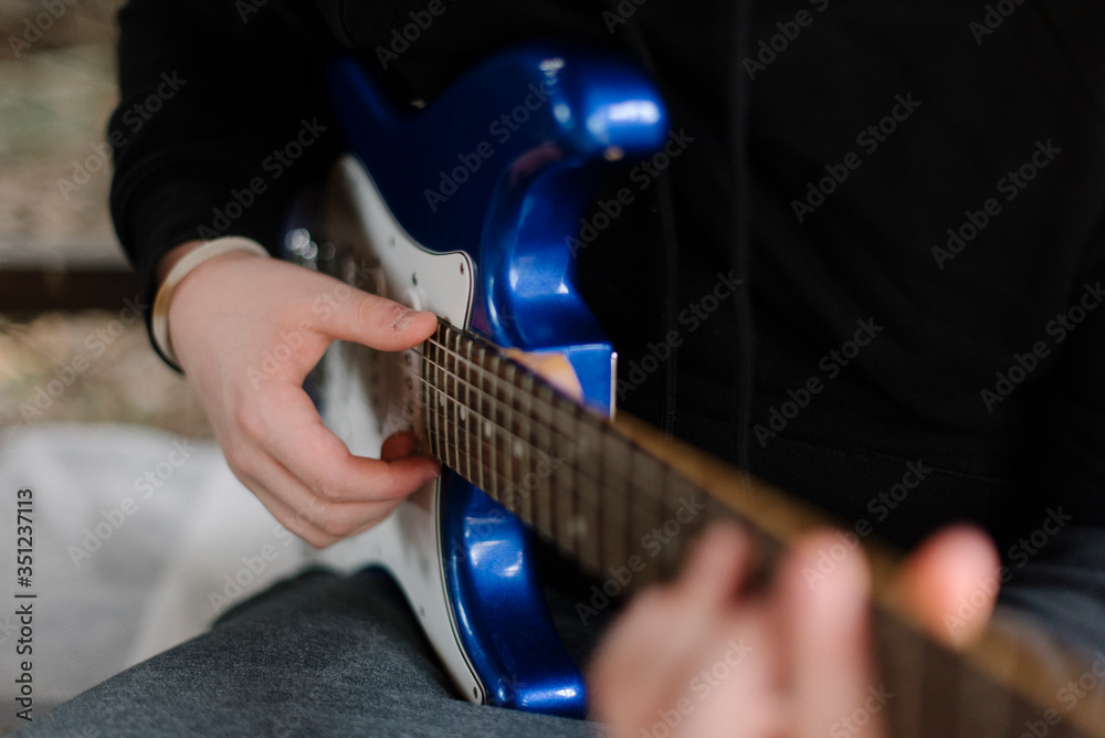 Fototapeta premium A hand on the guitar 