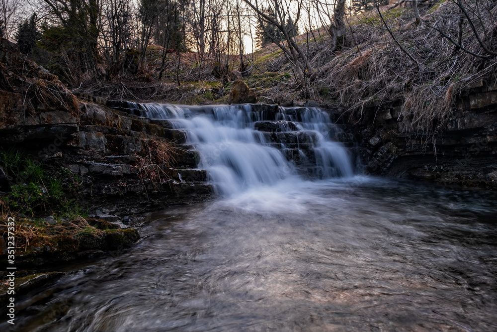 Waterfall Zalotomyatyi at the Zalotomyatyi river in carpatian mountains and green forest. National park Skolivski Beskidy. April 2020