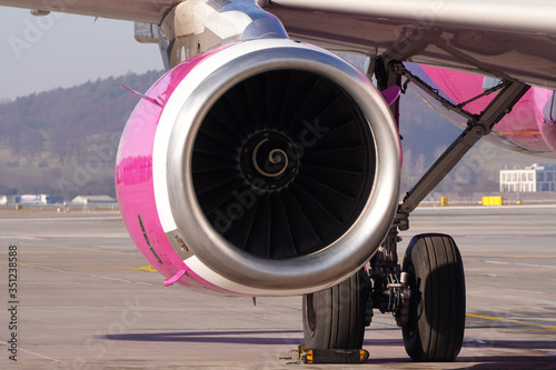 Jet engine of the passenger aircraft. The plane is on the tarmac, the wheels are blocked, the engine is stopped. Ban of passenger aviation flights due to the coronavirus pandemic.
