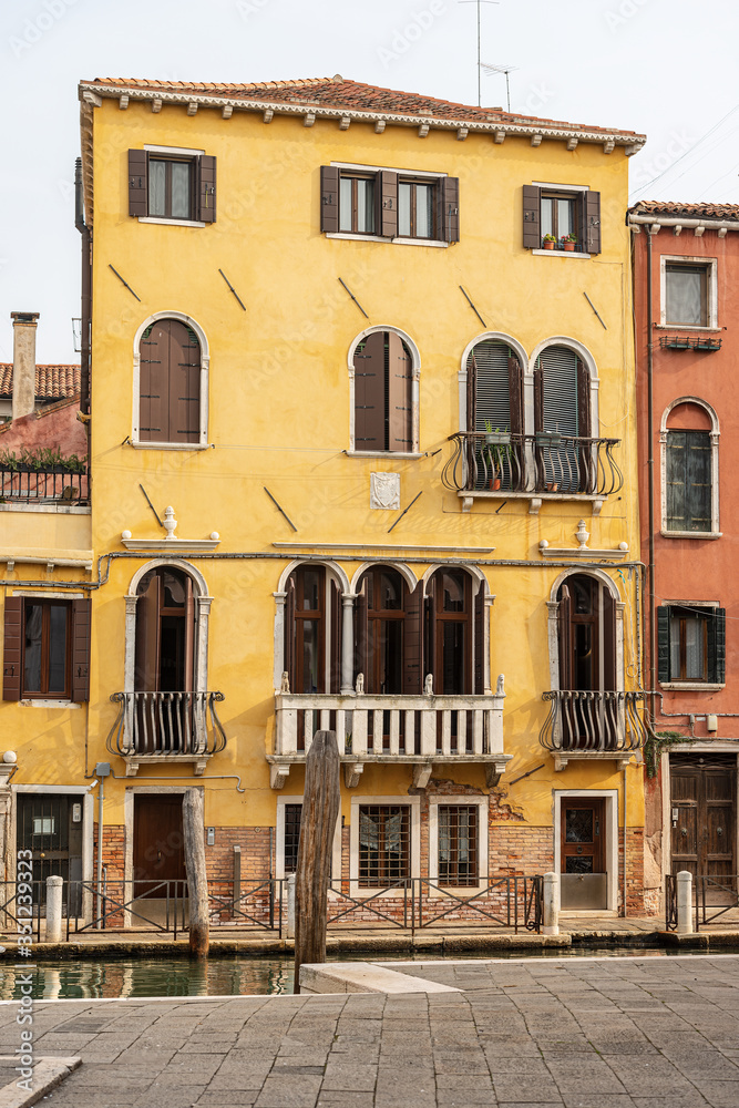 Venice downtown, close-up of old houses in front of a canal of the Venetian lagoon. UNESCO world heritage site, Veneto, Italy, Europe